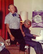 Harry Burnett on stage at Turnabout House, with Forman Brown at the piano