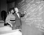 Performer Odetta examines the autograph wall