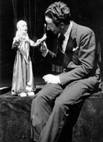 Yale Puppeteer Harry Burnett seated beside a clown puppet